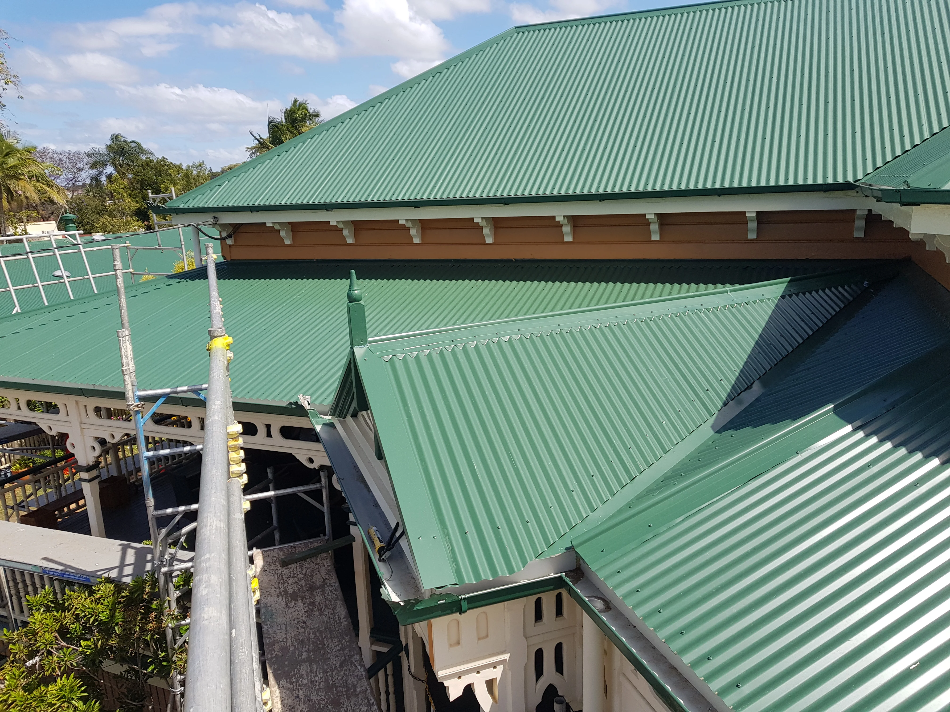 Enhance Roofing crew on a residential metal roof